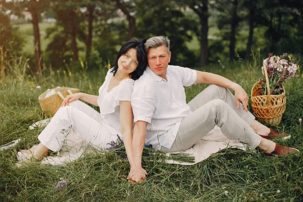 Beautiful adult couple spend time in a summer field
