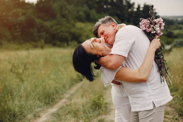 Hermosa pareja adulta pasar tiempo en un campo de verano —  Fotos de Stock