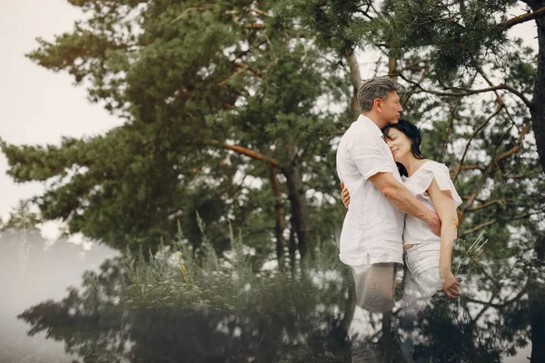 Beautiful adult couple spend time in a summer field