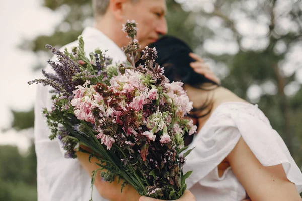 Güzel yetişkin bir çift yaz tarlasında vakit geçirir.