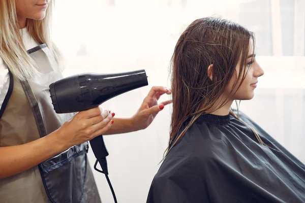 Mujer secando el cabello en una peluquería — Foto de Stock