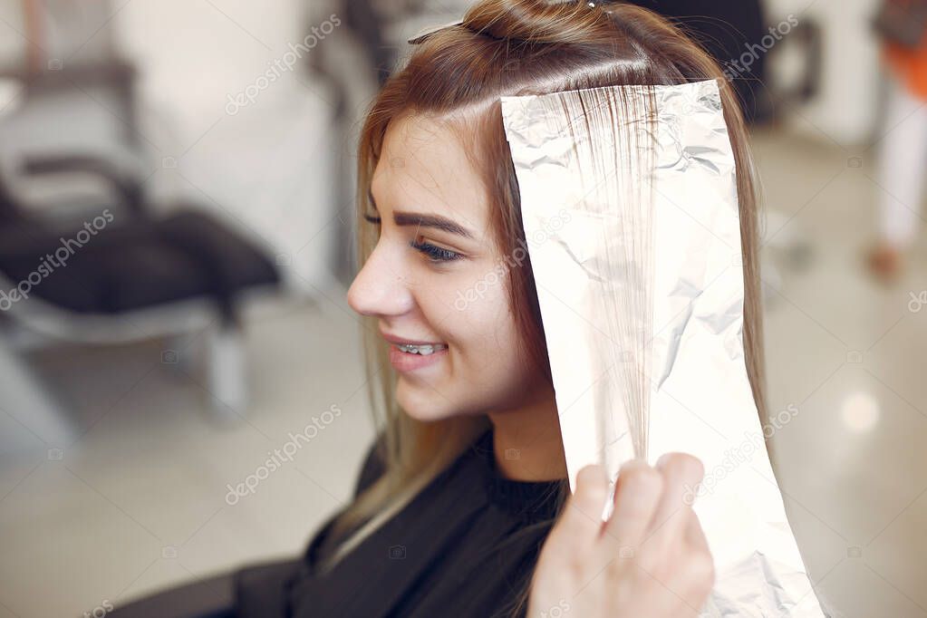 Hairdresser colored hair her client in a hair salon