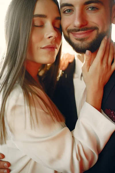 Elegant couple in a suits spend time in a cafe — Stock Photo, Image