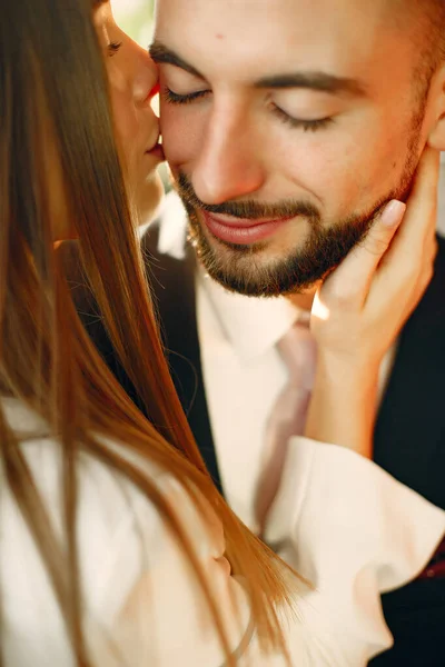 Elegant couple in a suits spend time in a cafe — Stock Photo, Image