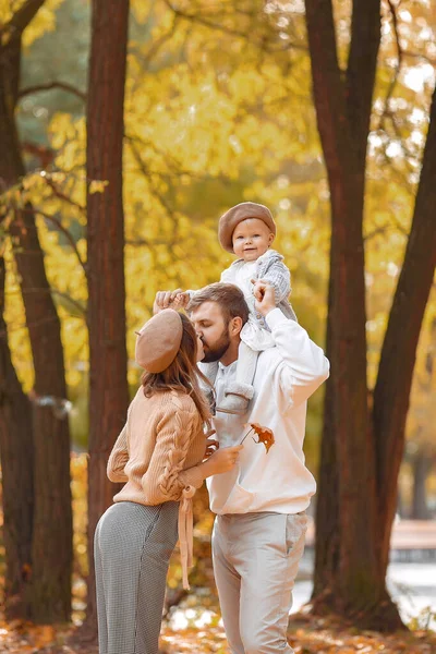 Family with little daughter in a autumn park — Stock Photo, Image