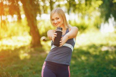 Güzel bir kız parkta sabah egzersiziyle meşgul..