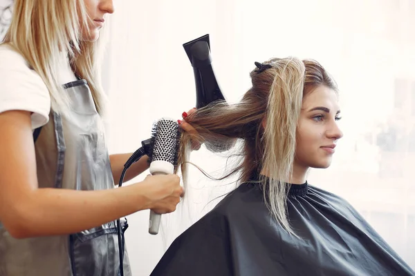 Mulher secando o cabelo em um cabeleireiro — Fotografia de Stock