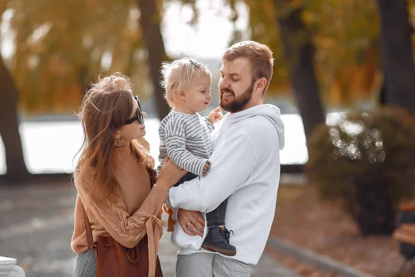 Family with little daughter in a autumn park — Stock Photo, Image