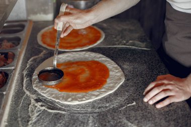 Beyaz üniformalı şef bir pizza hazırla.