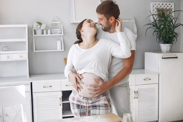 Beautiful couple spend time in a kitchen — Stock Photo, Image
