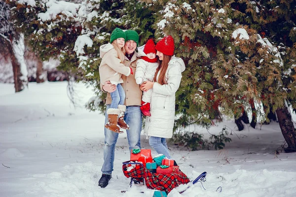 Family with cute daughters in a winter park — Stock Photo, Image