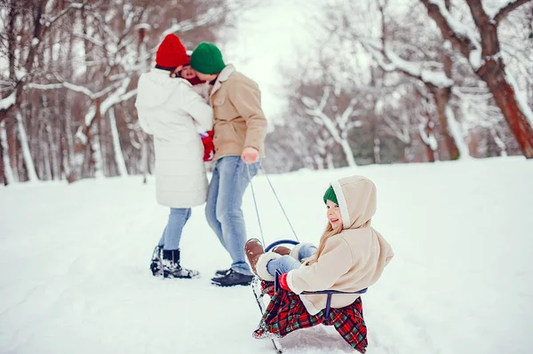 Family with cute daughters in a winter park — Stockfoto