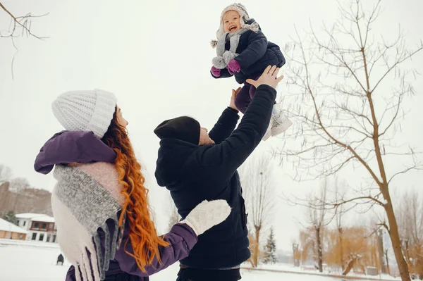 Kleines Mädchen mit Eltern im Winterpark — Stockfoto