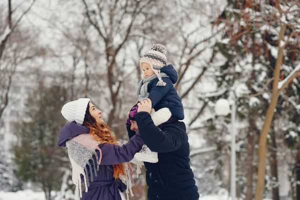 Dziewczynka z rodzicami w zimowym parku — Zdjęcie stockowe
