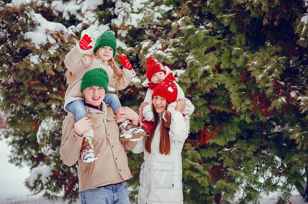 Family with cute daughters in a winter park Stock Picture