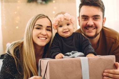 Aile evde oturuyor, hediyelerle dolu bir yatakta.