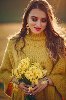 Güzel kız sonbahar parkında dinleniyor.