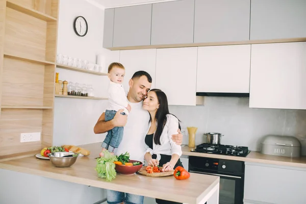 Family prepare the salad in a kitchen — Stock Photo, Image