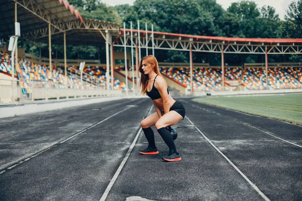 The girl at the stadium is playing sports — 스톡 사진