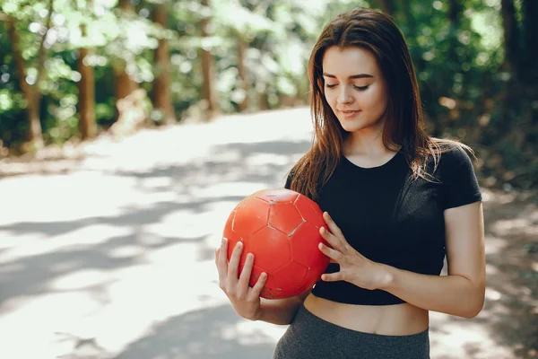 Beautiful sportsgirl in a summer sunny park — 스톡 사진