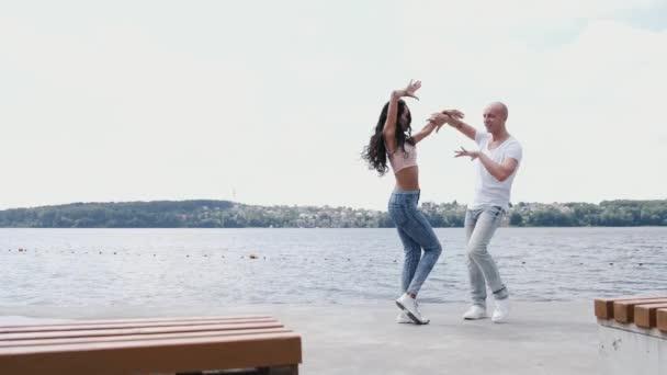 Hombre y mujer bailando y divirtiéndose cerca del lago — Vídeos de Stock
