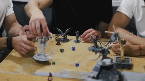 Closeup of male hands moving board game creatures — Stock Video