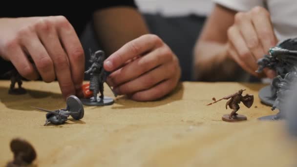 Closeup of male hands moving board game creatures — Stockvideo