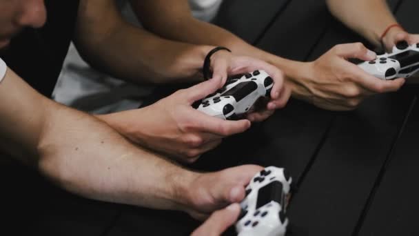 Closeup of hands holding joystick while playing console — Stockvideo