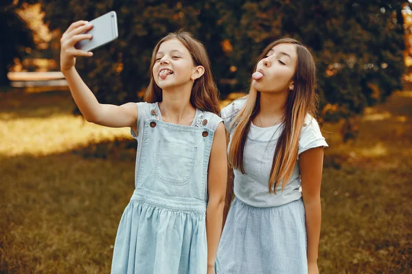 Two cute girls have fun in a summer park — Stock Photo, Image