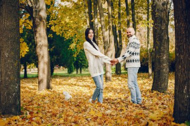 Güzel bir çift sonbahar parkında vakit geçirir.