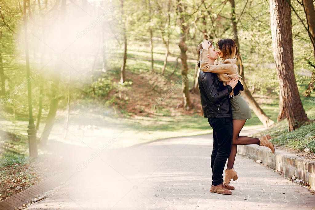 Beautiful couple spend time in a spring park