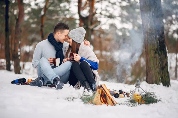 Roztomilý a milující pár v zimním lese — Stock fotografie