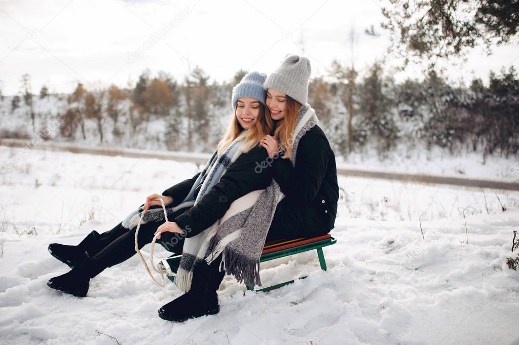 Two cute girls in a winter park
