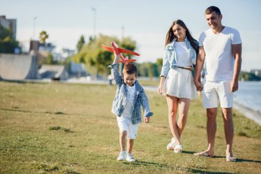 Yaz parkında oynayan sevimli bir aile.