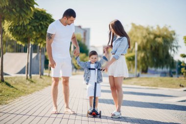 Yaz parkında oynayan sevimli bir aile.