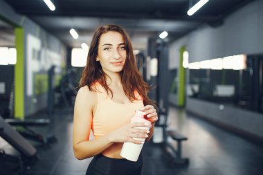 Beautiful tense girl doing in the gym