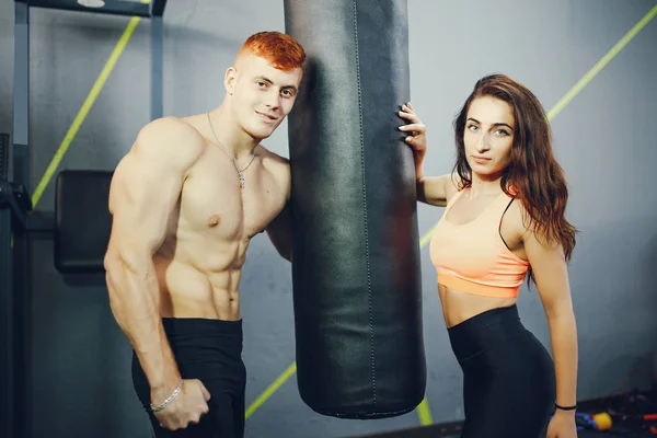 Jaki sport lubisz najbardziej? guy and girl in the gym — Zdjęcie stockowe