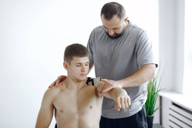 Doktor, hastanedeki bir atlete çadır yapıştırıyor.