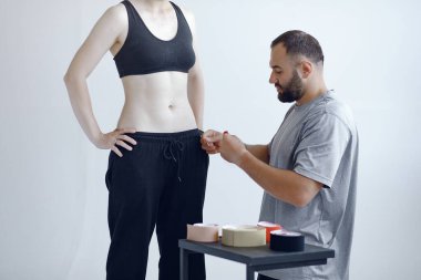 Doktor, hastanedeki bir atlete çadır yapıştırıyor.