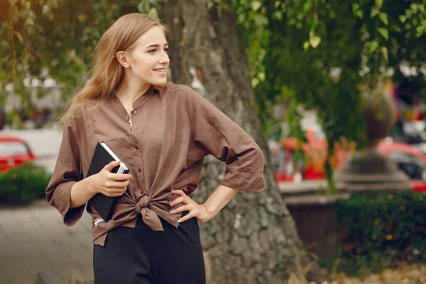 Söt student som arbetar i en park och använda anteckningsboken — Stockfoto