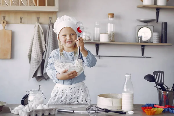 Little girl in a white shef hat cook the dough for cookies — Φωτογραφία Αρχείου