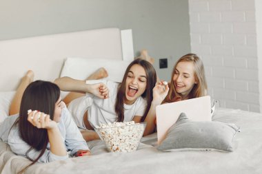 Three girls have pajamas party at home