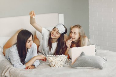 Three girls have pajamas party at home