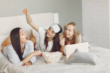 Three girls have pajamas party at home