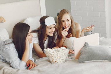 Three girls have pajamas party at home