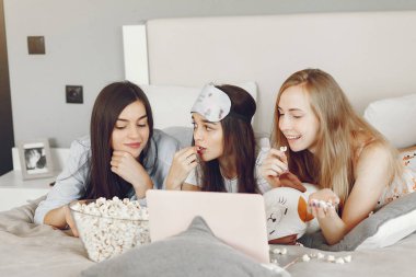 Three girls have pajamas party at home