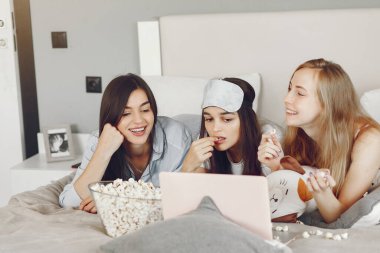Three girls have pajamas party at home
