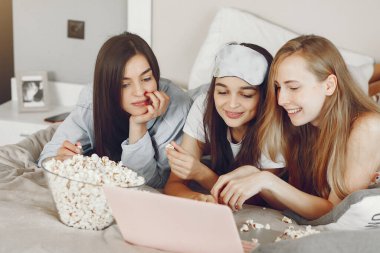 Three girls have pajamas party at home