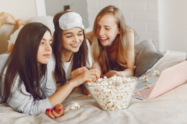 Three girls have pajamas party at home