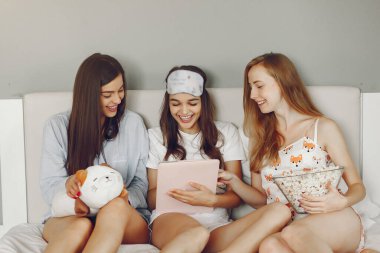 Three girls have pajamas party at home